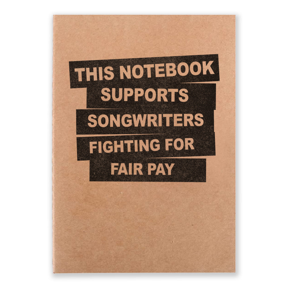 A notebook that say "This Notebook Supports Songwriters Fighting For Equal Pay" on the front