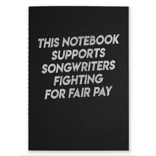 One black notebook that say "This Notebook Supports Songwriters Fighting For Equal Pay" on the front