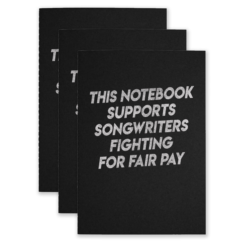 Three black notebooks that say "This Notebook Supports Songwriters Fighting For Equal Pay" on the front