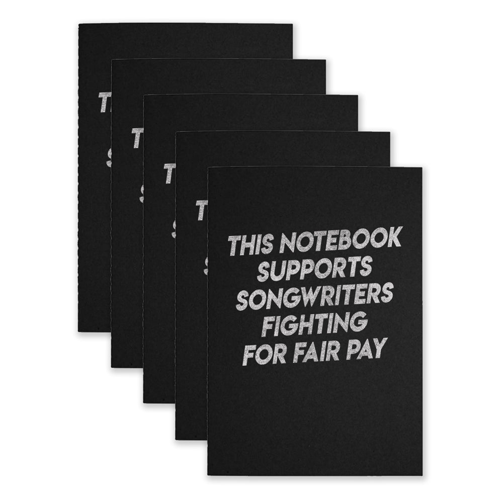 Five black notebooks that say "This Notebook Supports Songwriters Fighting For Equal Pay" on the front