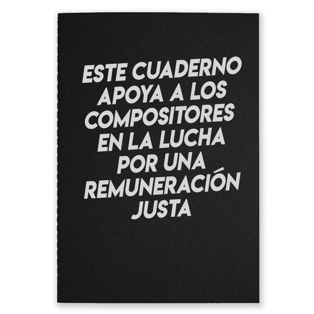 A black notebook that says "Este Cuaderno Apoya A Los Compistores En La Lucha Por Una Remuneracion Justa" on the front with white text