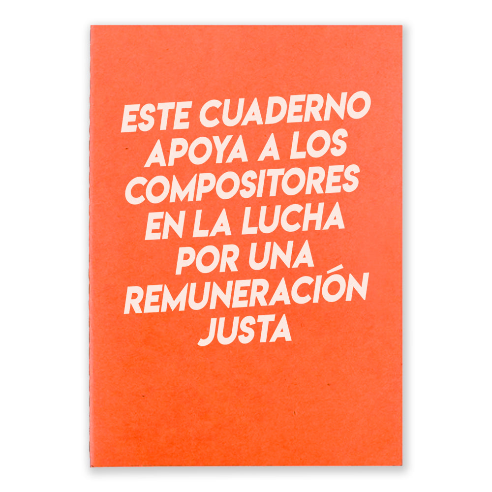 An orange notebook that says "Este Cuaderno Apoya A Los Compistores En La Lucha Por Una Remuneracion Justa" on the front