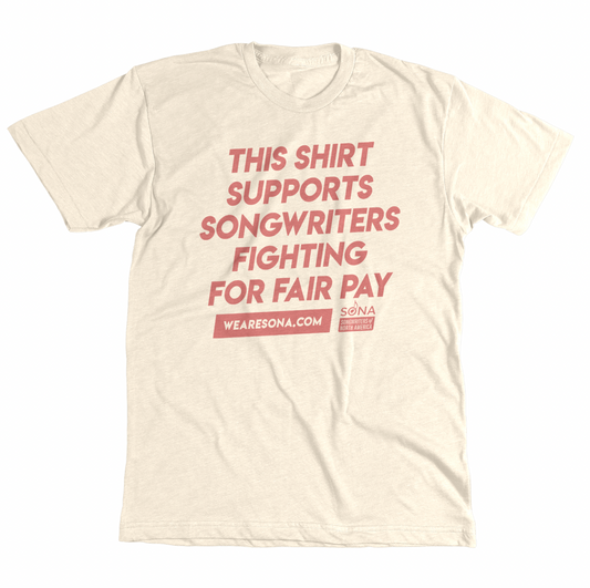 An off-white tshirt that has pink text that says "This shirt supports songwriters fighting for fair pay"