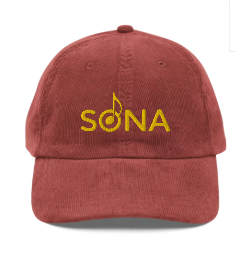 A red corduroy hat that says SONA in yellow text 