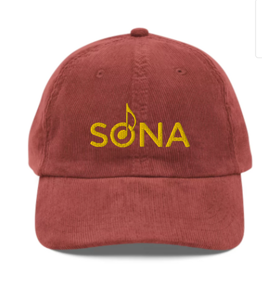 A red corduroy hat that says SONA in yellow text 